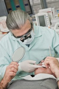 emergency dentist working on patients dental implants
