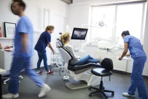 woman and busy dentists due to a dental emergency