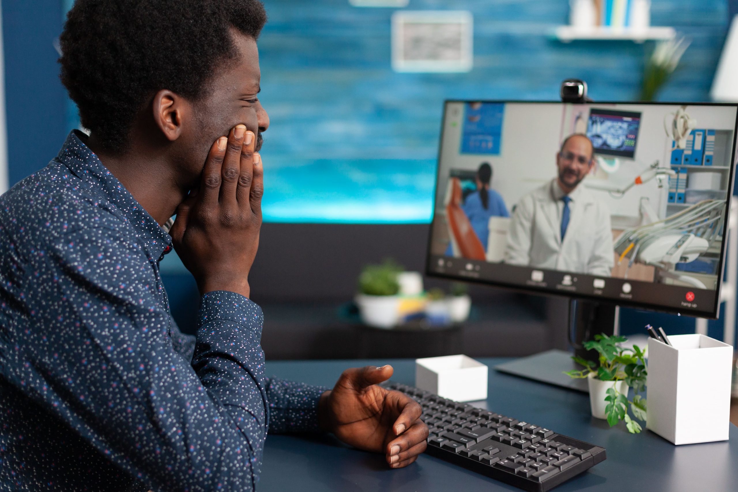 person having an online dentist appointment for tooth pain